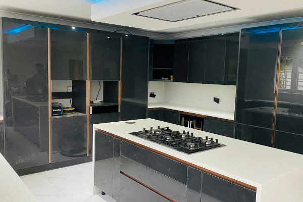 Fourth view of high-gloss anthracite kitchen in Wembley with bronze trim and blue LED lighting