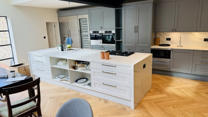 Second view of dove-grey shaker kitchen in Richmond with pantry-style fridge tower and twin ovens