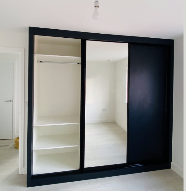 Second view of matt black sliding wardrobe with mirrored door and white interior