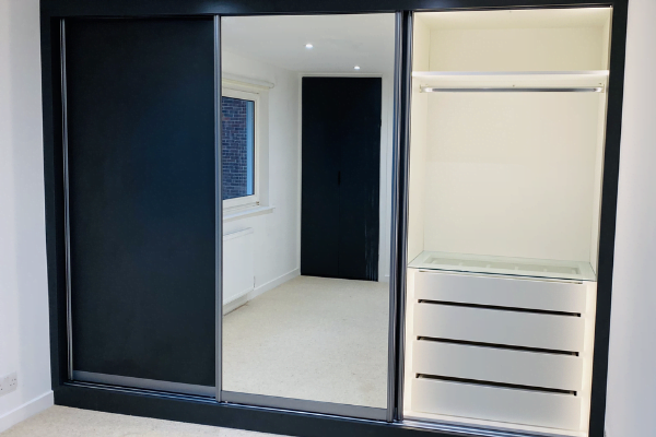 Fifth view of matt black sliding wardrobe with mirrored door and white interior