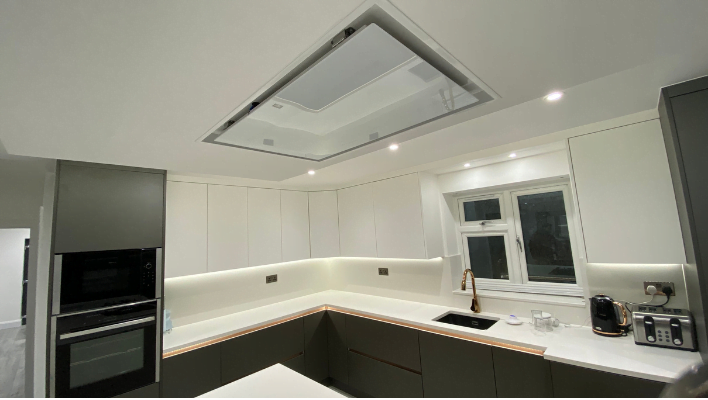 Tenth view of matt khaki-green handleless kitchen in Isleworth with waterfall quartz island