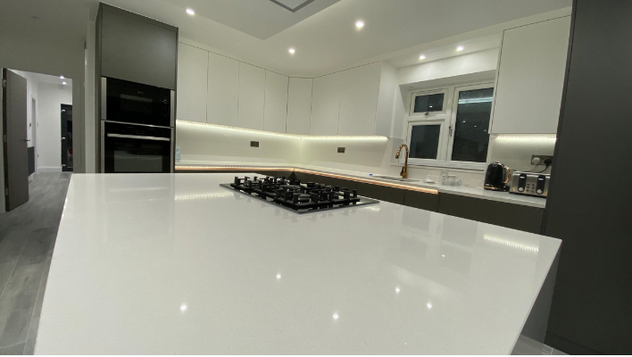 Fifth view of matt khaki-green handleless kitchen in Isleworth with waterfall quartz island