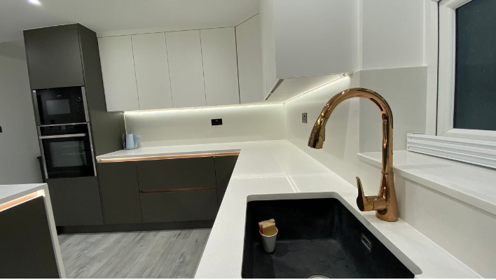 Seventh view of matt khaki-green handleless kitchen in Isleworth with waterfall quartz island