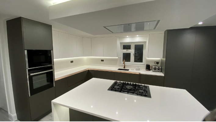 Ninth view of matt khaki-green handleless kitchen in Isleworth with waterfall quartz island