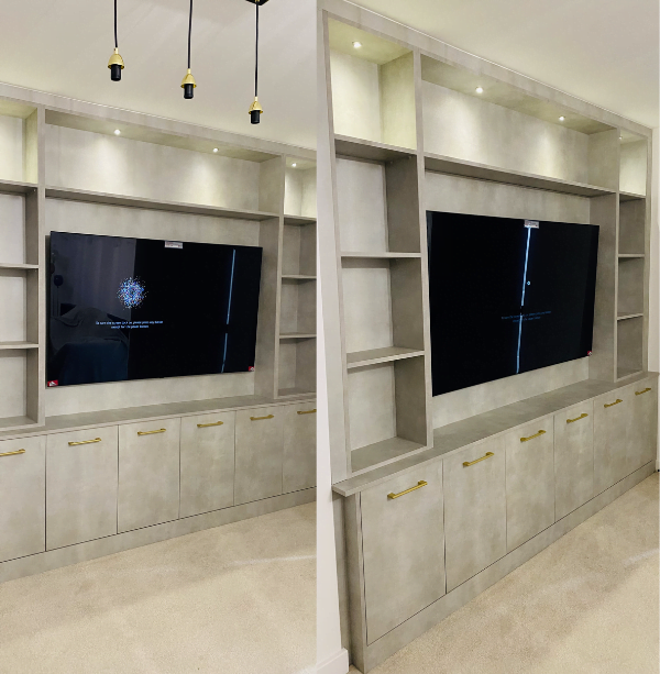Second view of grey concrete-effect media wall in Harrow showing open shelving and pendant lighting
