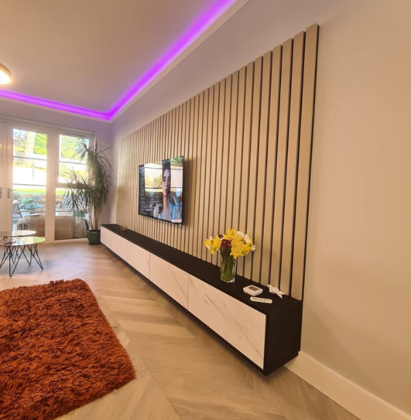 Oak slatted media wall in a London living room with floating dark wood and marble-effect TV unit