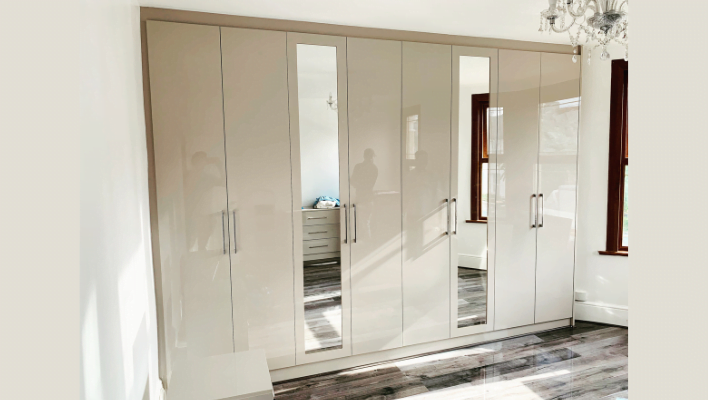 Second view of matt stone and cream hinged wardrobe with black-framed doors