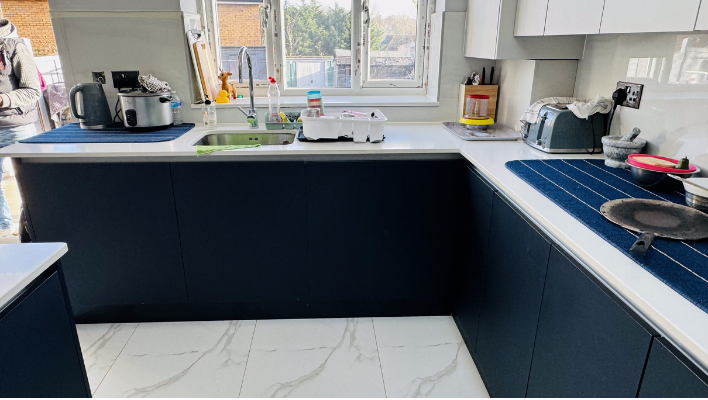 Two-tone navy and cream matt kitchen in Romford with roof lanterns and white quartz island