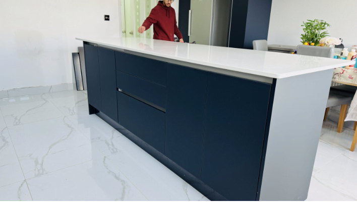 Second view of two-tone navy and cream matt kitchen in Romford with quartz worktop