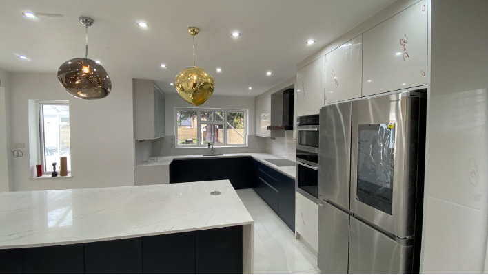 Second view of two-tone navy and white kitchen in Putney with pendant lighting over the island