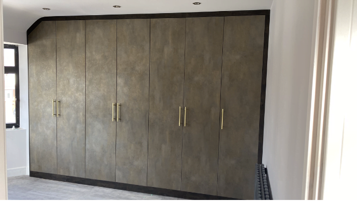 Second view of white matt loft wardrobe fitted under sloped eaves ceiling