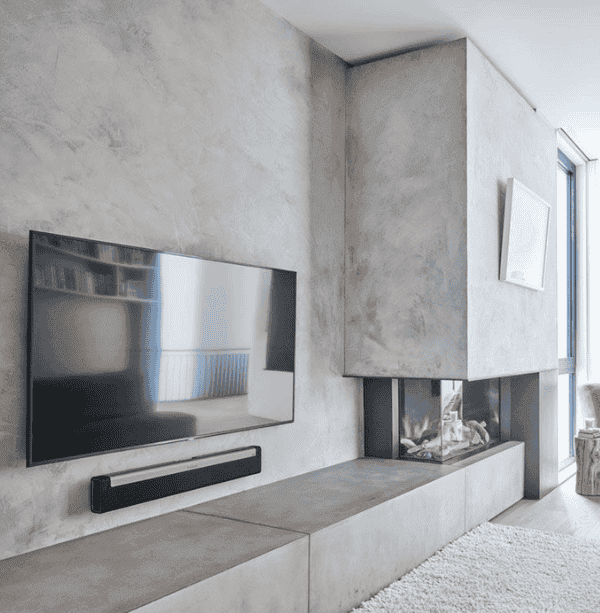 Modern concrete-look media wall with recessed fireplace and mounted TV in a stylish British flat