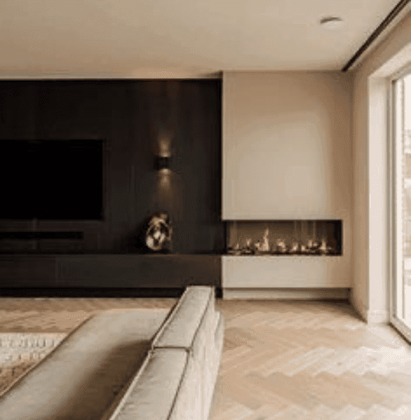 Luxury fitted media wall with dark wood panelling and corner fireplace in a modern UK home